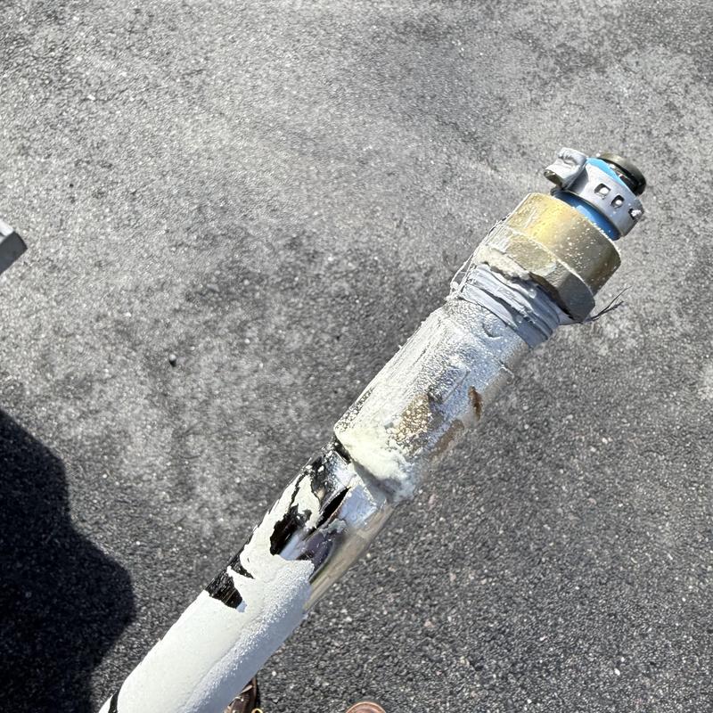 Burst silcock pipe with damage and corrosion outdoors