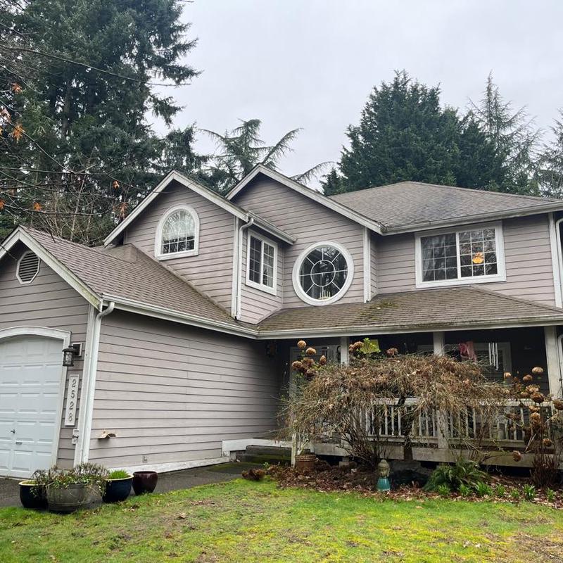 Asphalt shingle roofing on two-story residential house