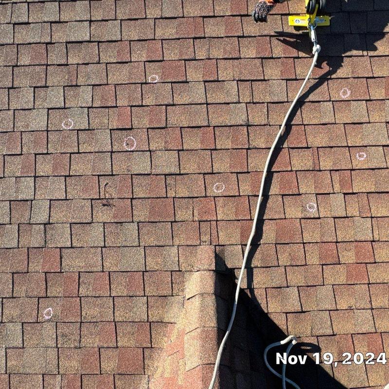 Owen Corning Oakridge asphalt shingles with hail damage marks