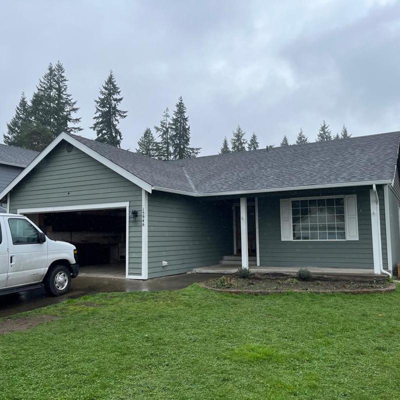 Asphalt shingle roof inspection on gray house