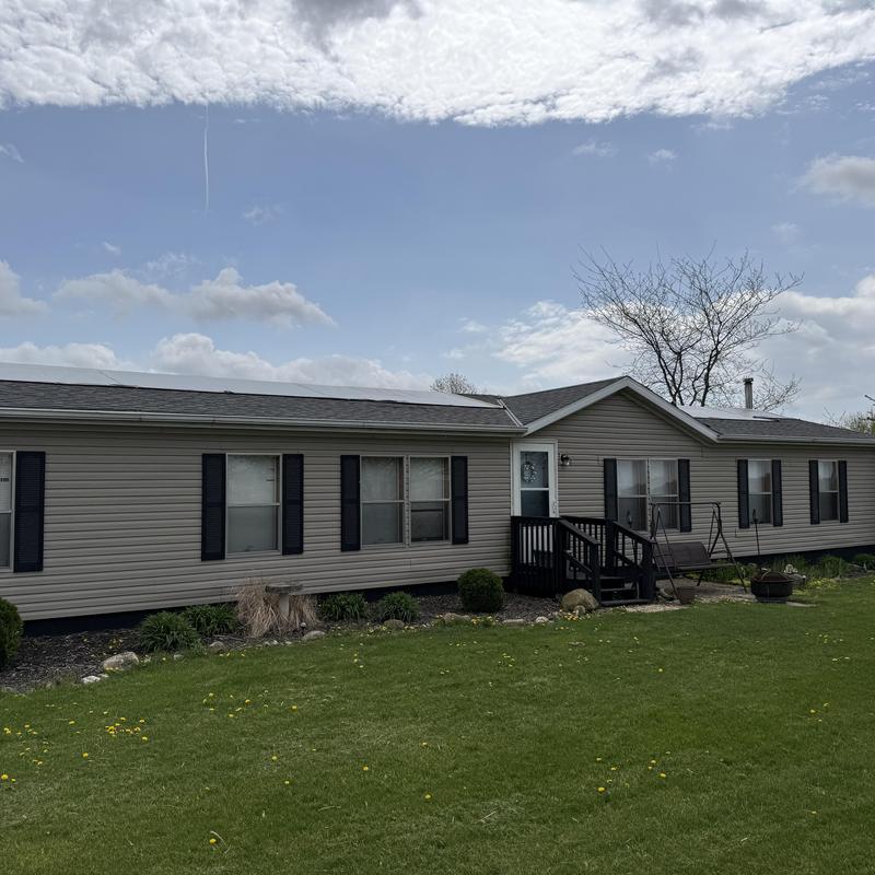 Asphalt shingle roof with solar panels on mobile home