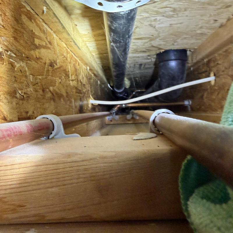 Copper water pipes inside wall cavity with drain pipe