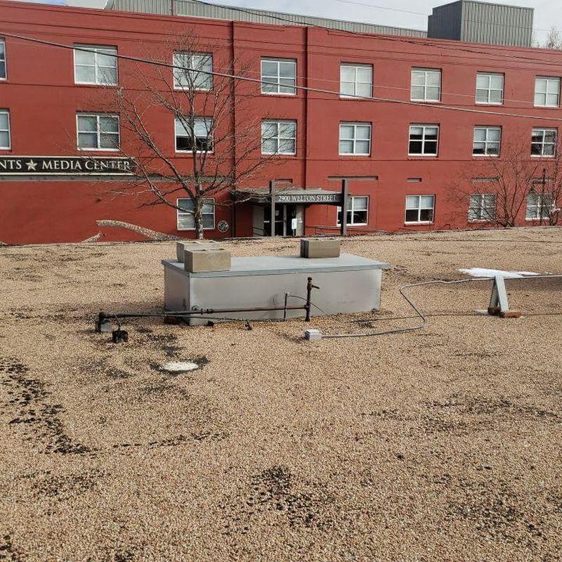 Tar and gravel flat roof showing deterioration signs