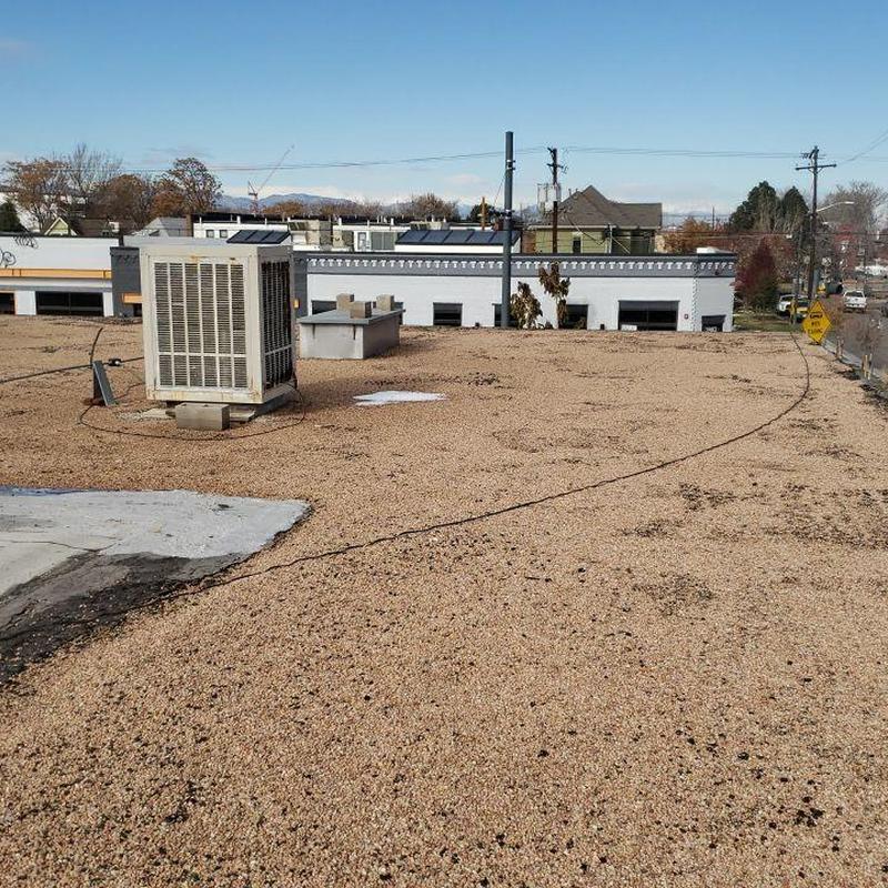 Tar and gravel flat roof with HVAC unit