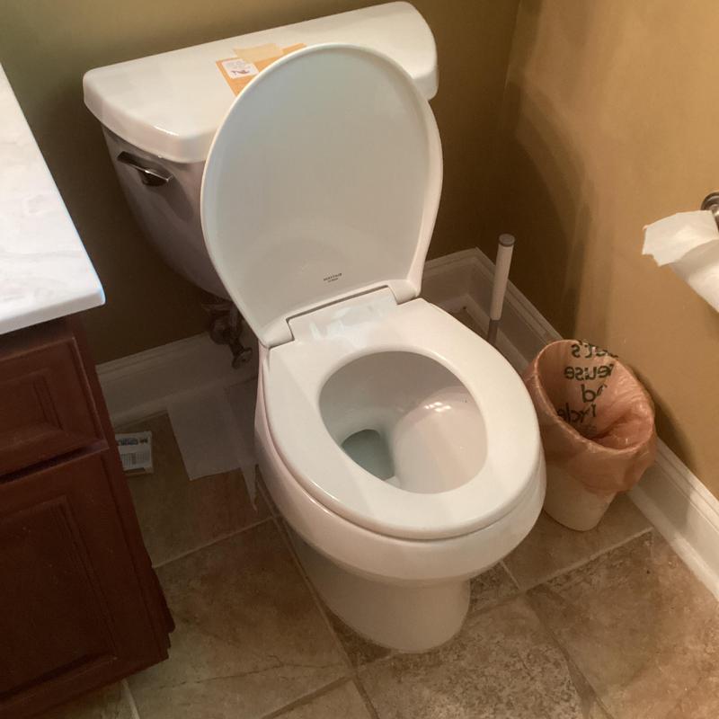 Bathroom toilet with open lid and round seat