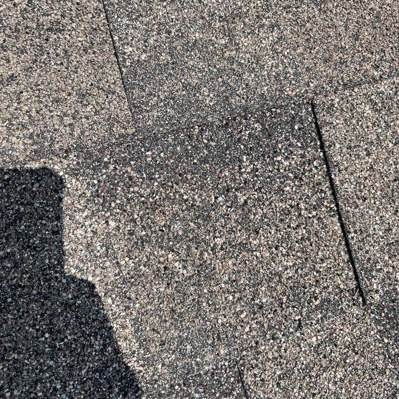 Asphalt shingles roof with hail damage close-up