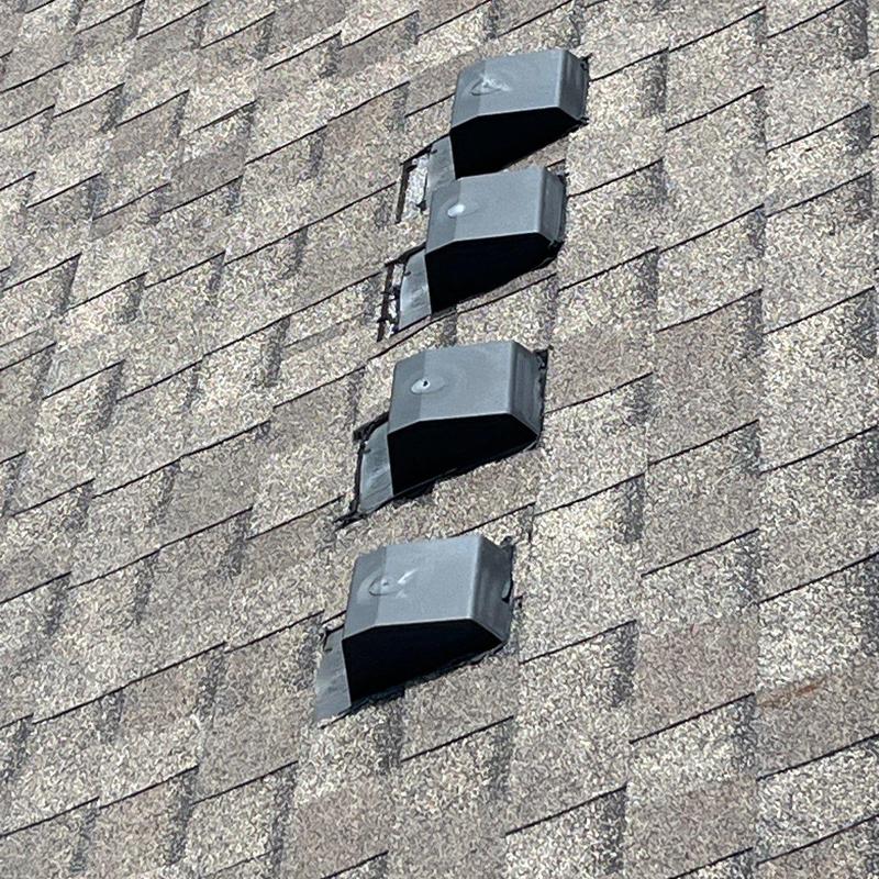 Roof shingles and vent covers with hail damage