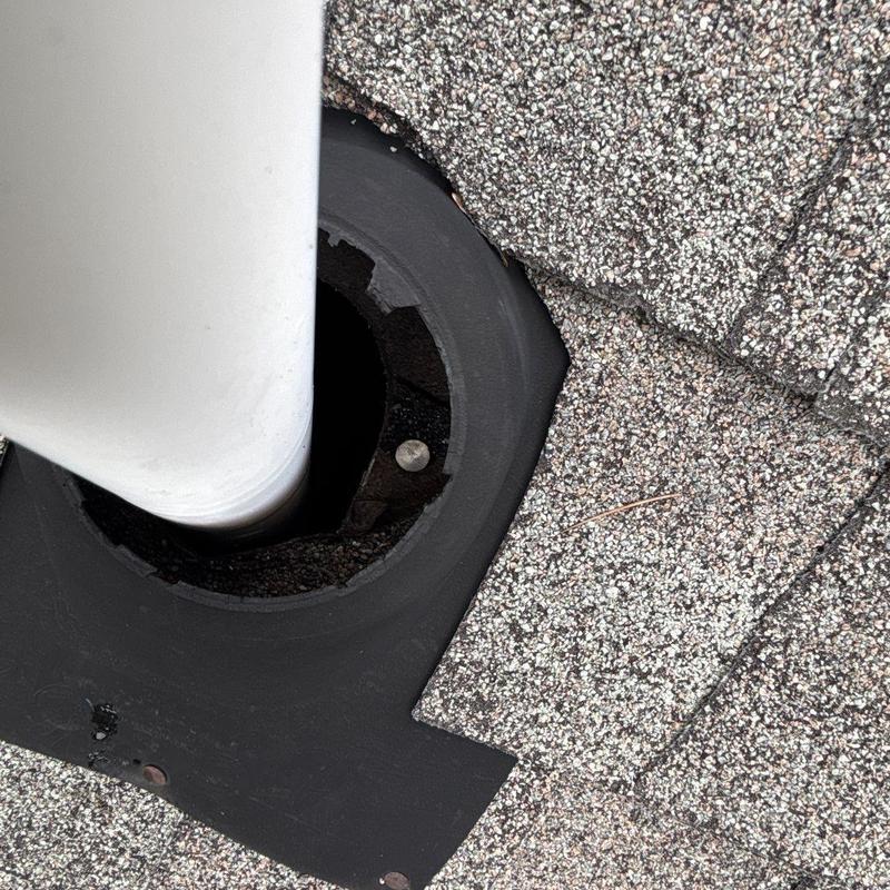 Roof vent flashing with cracked seal on shingles