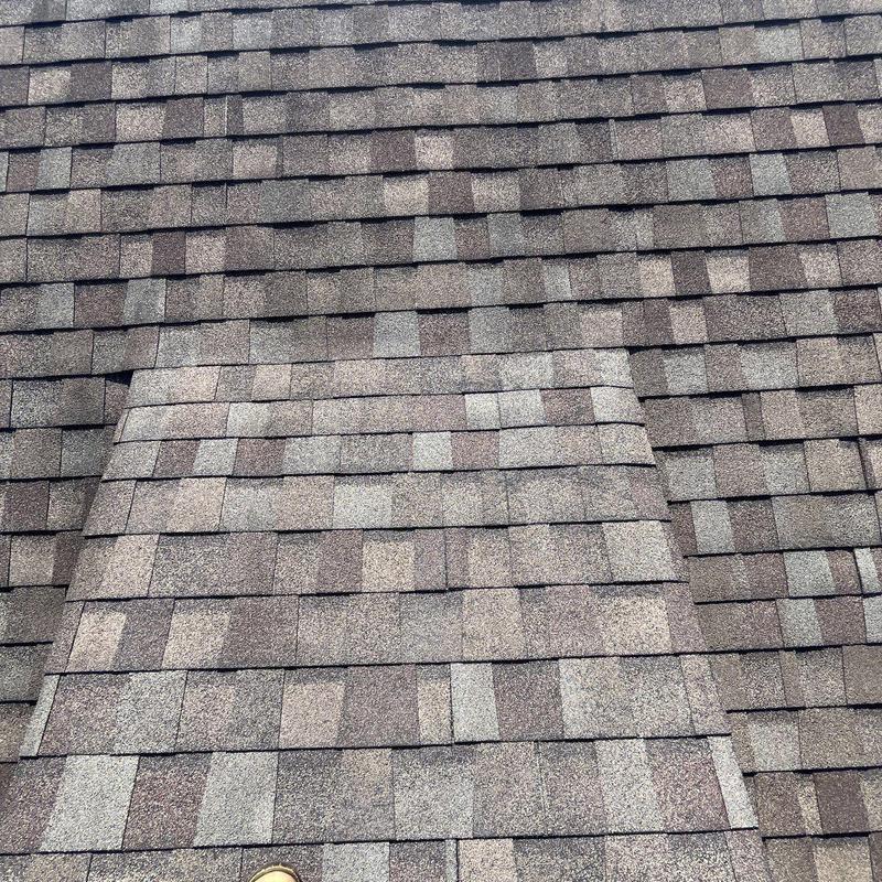 Asphalt shingles with hail damage and granule loss