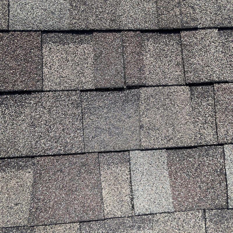 Hail-damaged asphalt shingles with granule loss