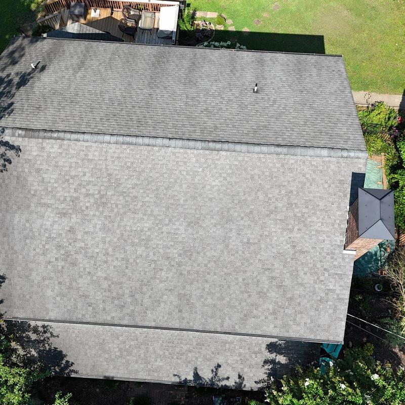 Asphalt shingle roof showing wear from hail damage