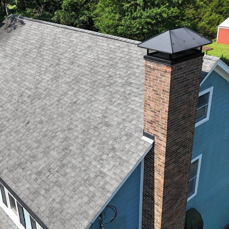 Asphalt shingle roof with brick chimney inspection