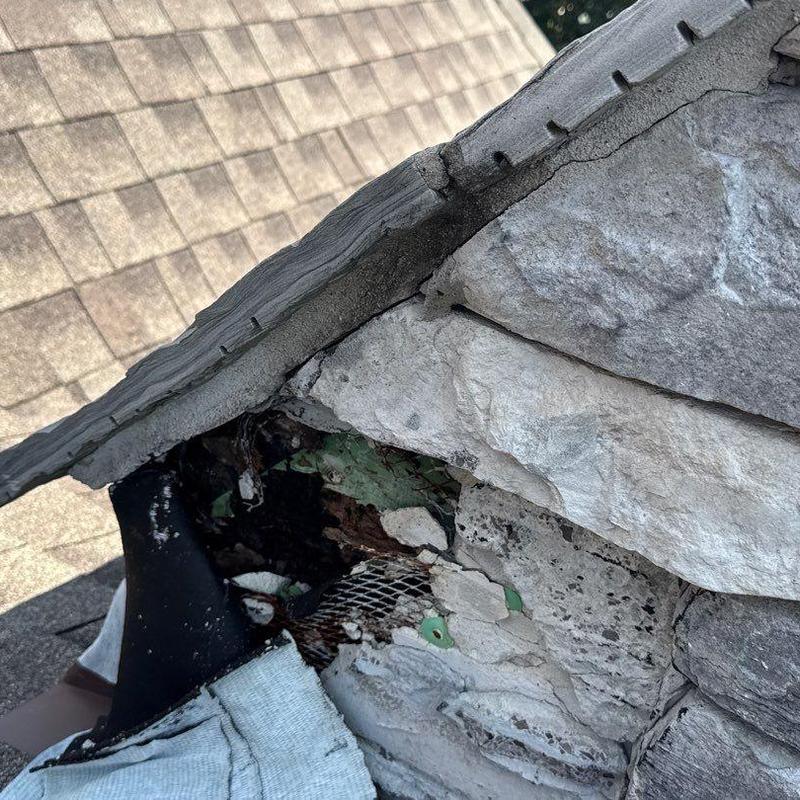 Roof flashing damage with deteriorated sealant and shingles