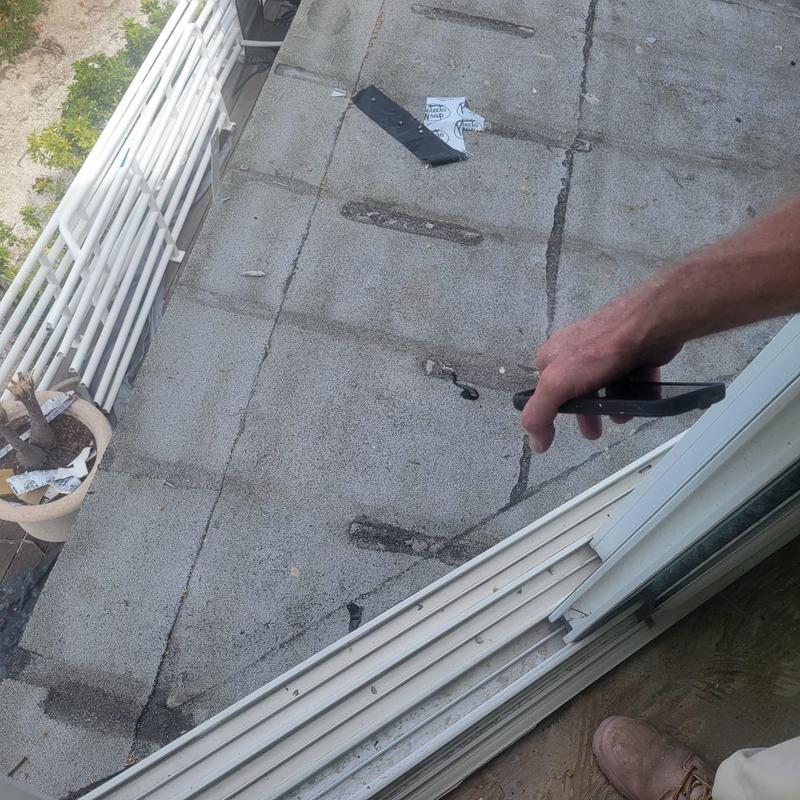 Flat roof inspection with visible patch repairs