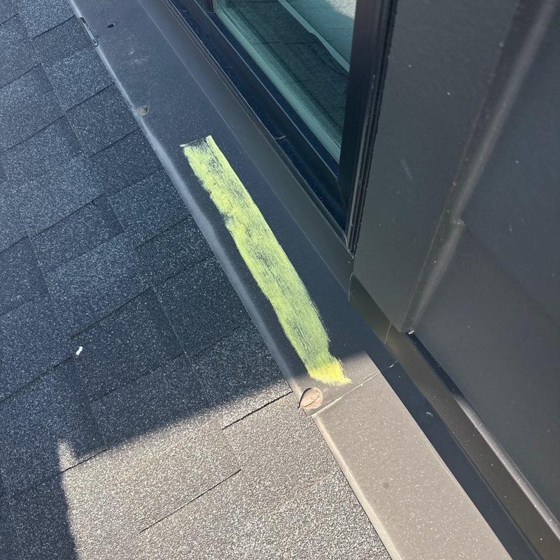 Roof flashing with marked hail damage near window