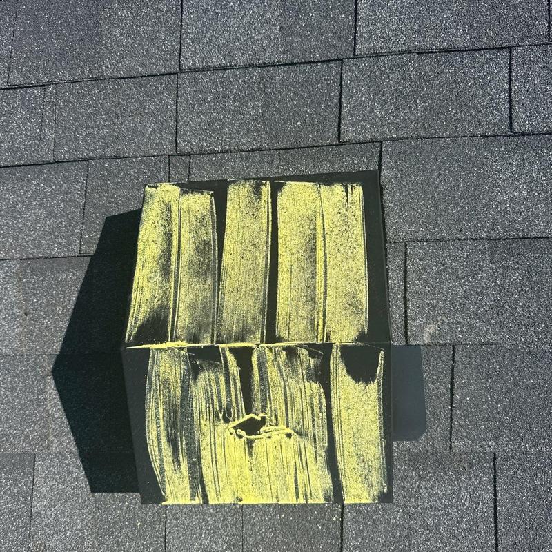Asphalt shingles with hail damage marked in yellow