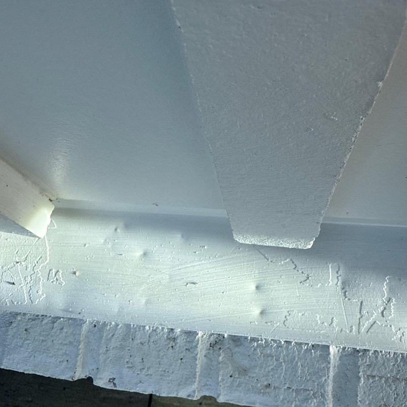 Roof fascia board with paint bubbles and damage