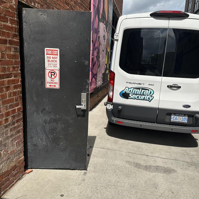 Exit device lever trim on fire exit door