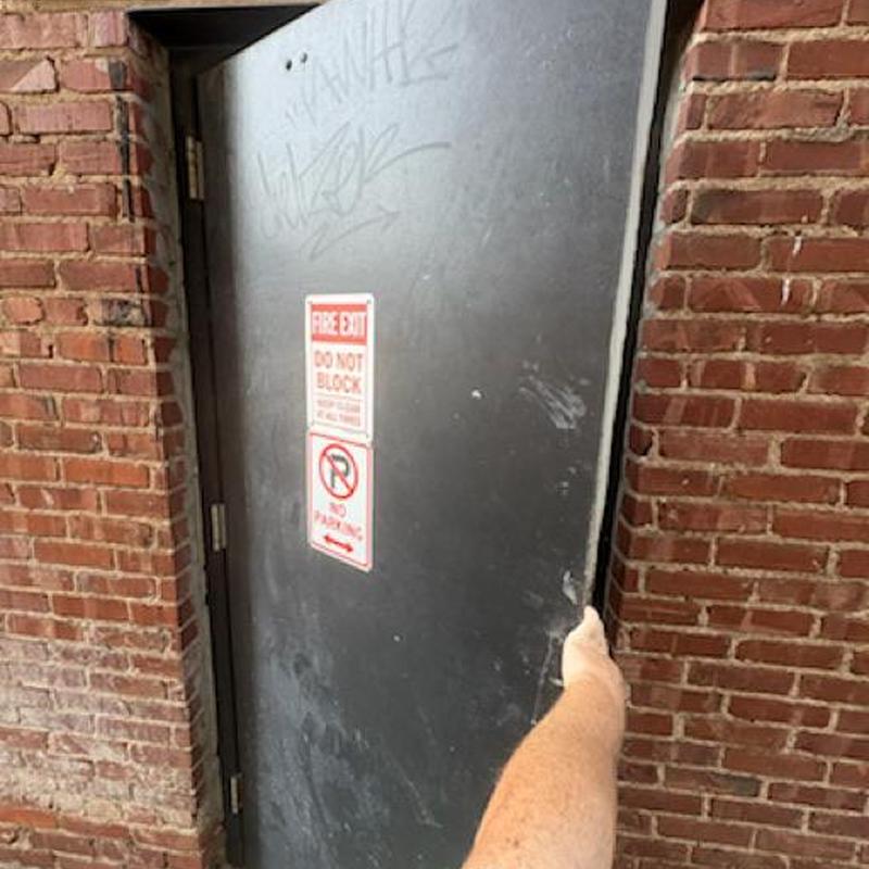 Exit device lever trim on fire exit door with arm