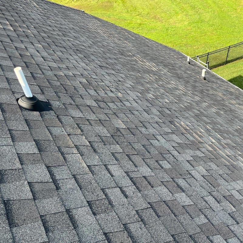 Asphalt shingle roof with visible hail damage spots