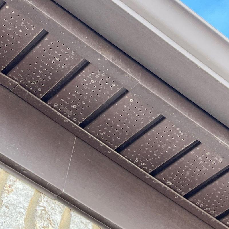 Soffit panel with multiple hail damage marks