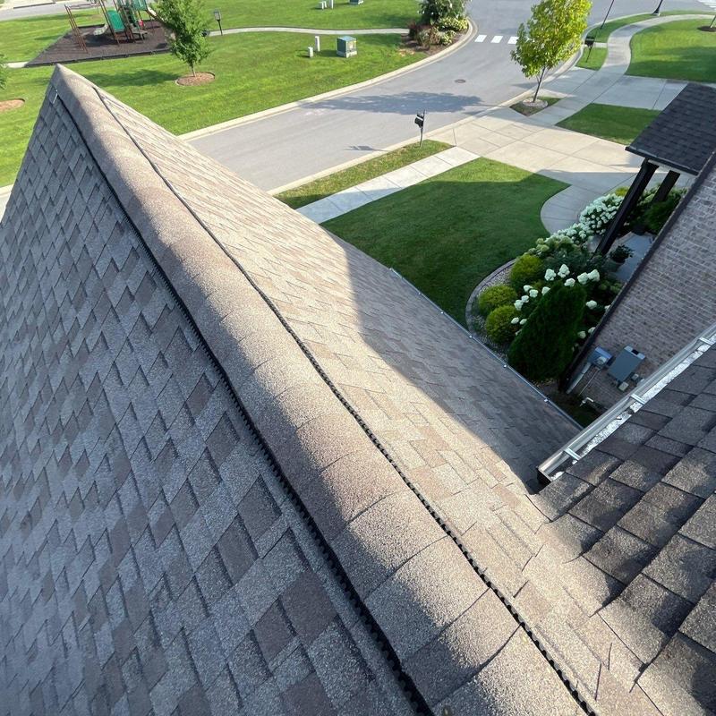 Asphalt shingle roof ridge with ventilation detail