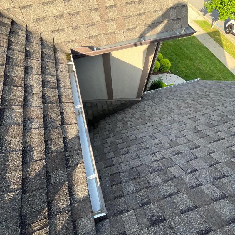 Roof shingles and gutter with hail damage inspection