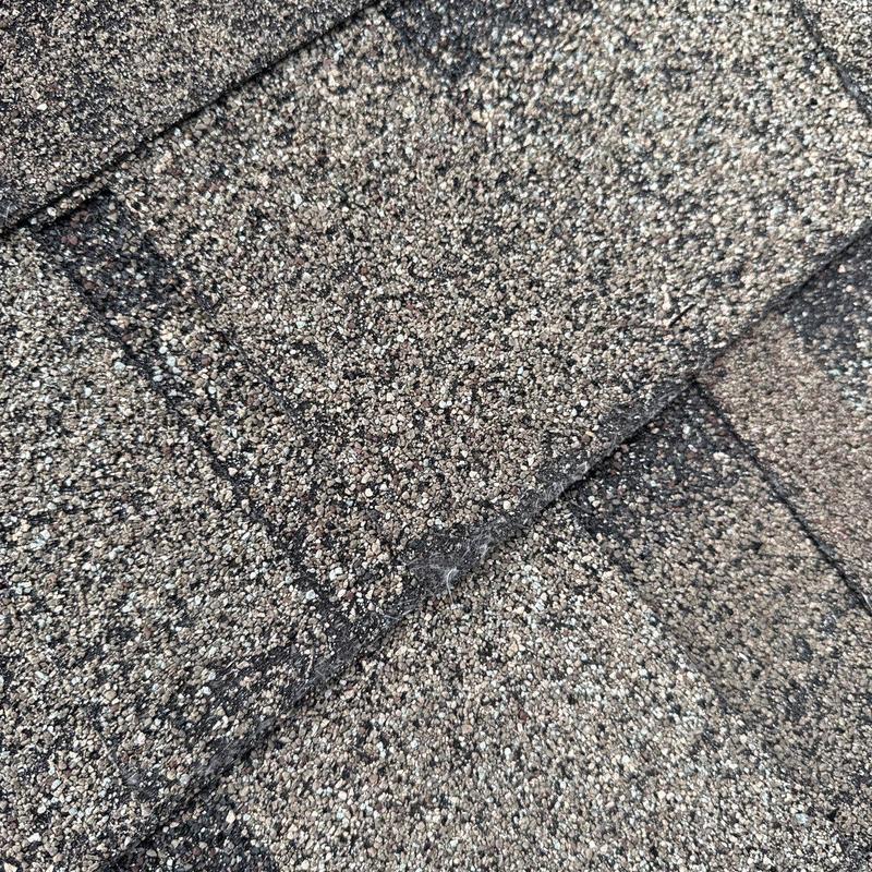 Roof shingles with hail damage and wear close-up