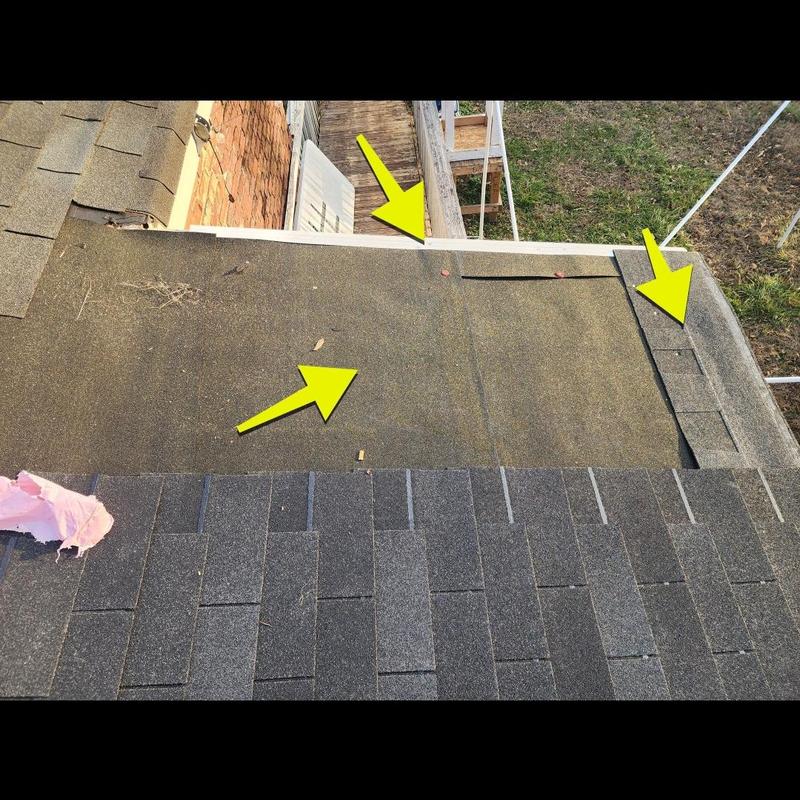 Flat roof damaged shingles with yellow arrows