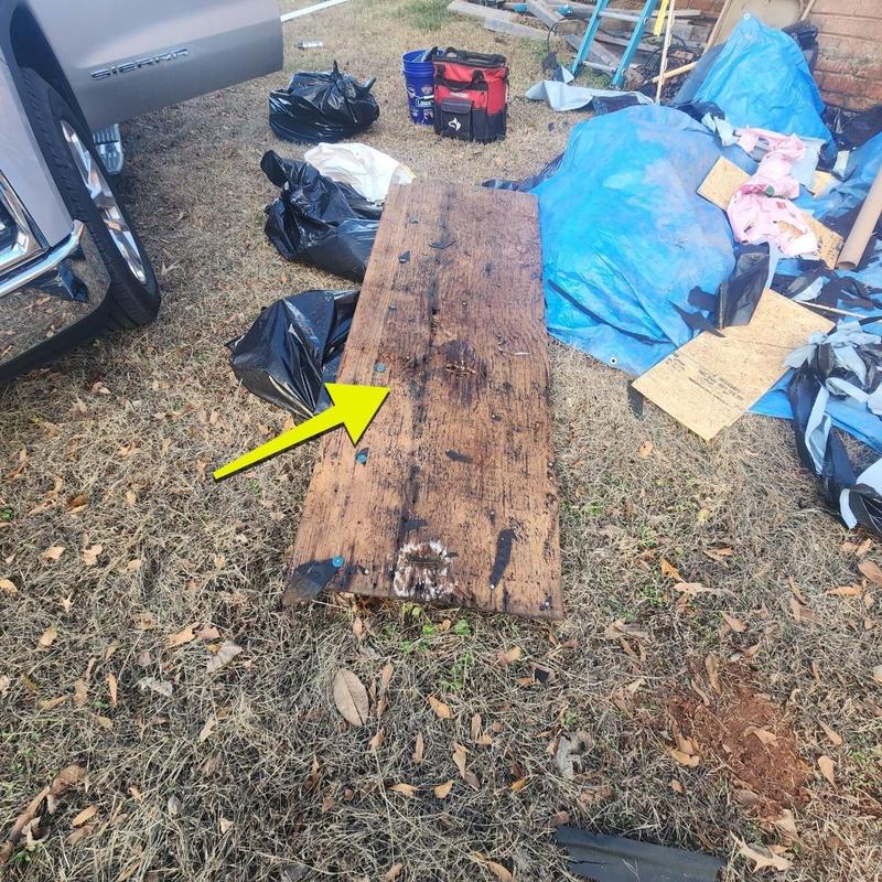 Damaged wooden roof decking removed on yard grass