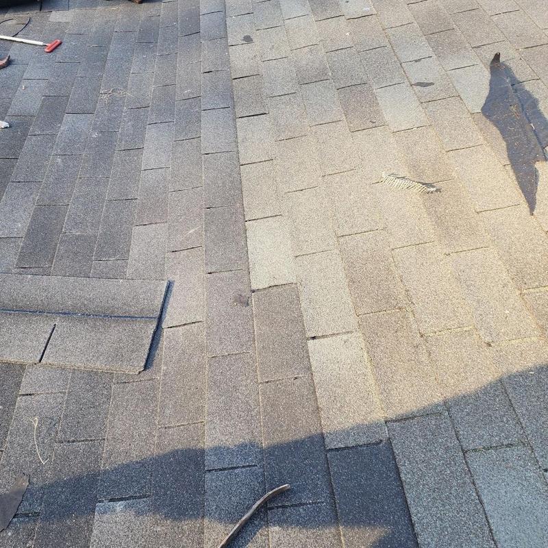 Storm-damaged asphalt shingles on roof in Spartanburg, SC