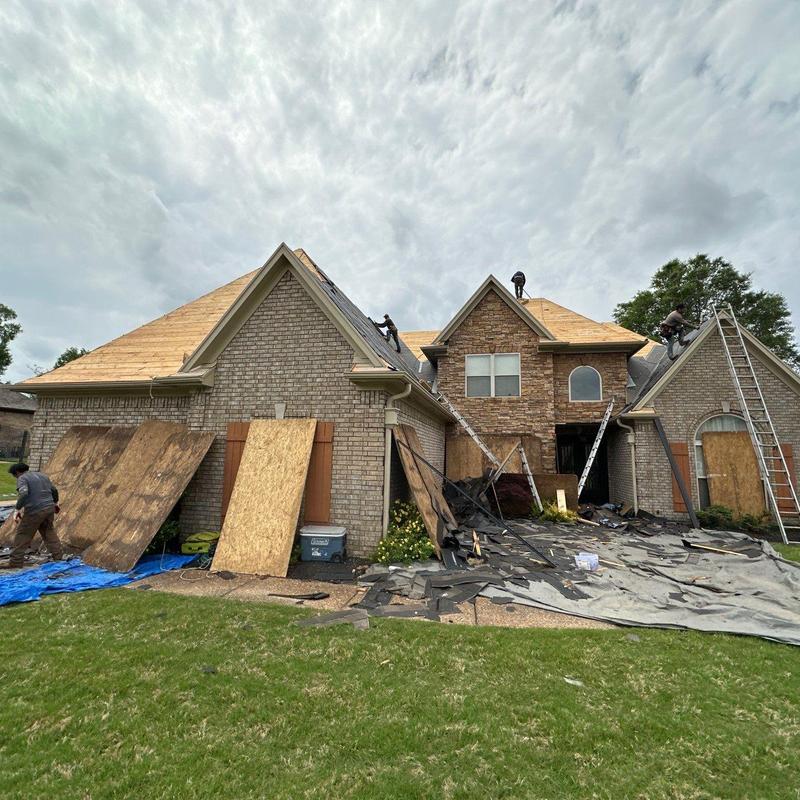 Asphalt shingle roof removal and replacement in progress