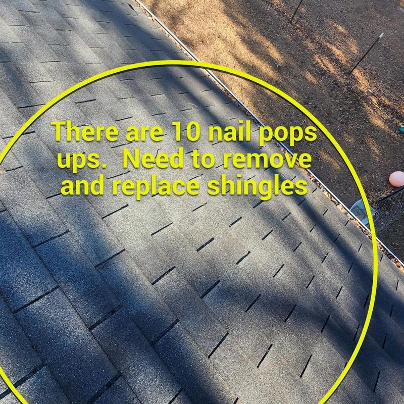 Roof shingles with nail pops on asphalt roof
