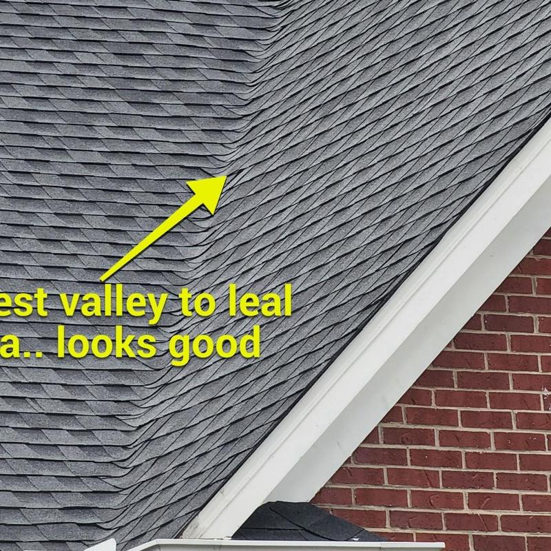 Roof valley and shingle area near brick wall