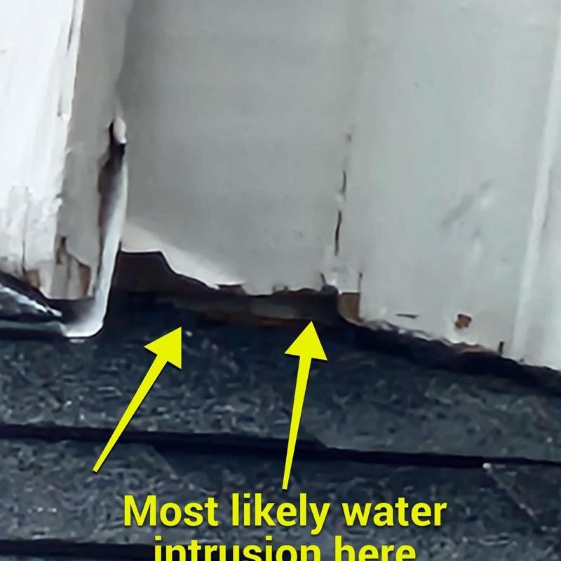 Rooftop wall flashing with water damage and gaps