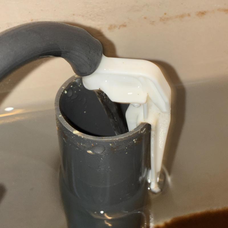 Toilet fill valve inside tank with water flowing