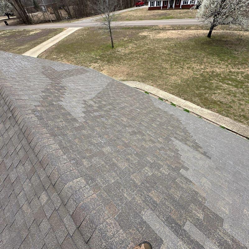 Asphalt shingle roof with visible wear and staining