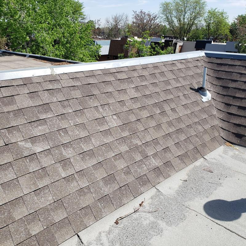 Shingle roof with visible hail damage on slope