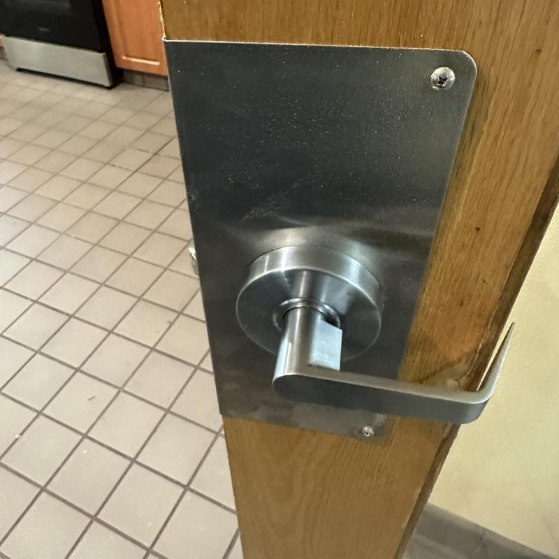 Commercial door lever lock with metal wrap installation
