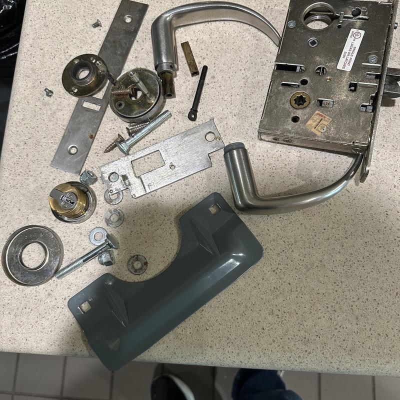 Commercial door lock cylinder and handle parts on countertop