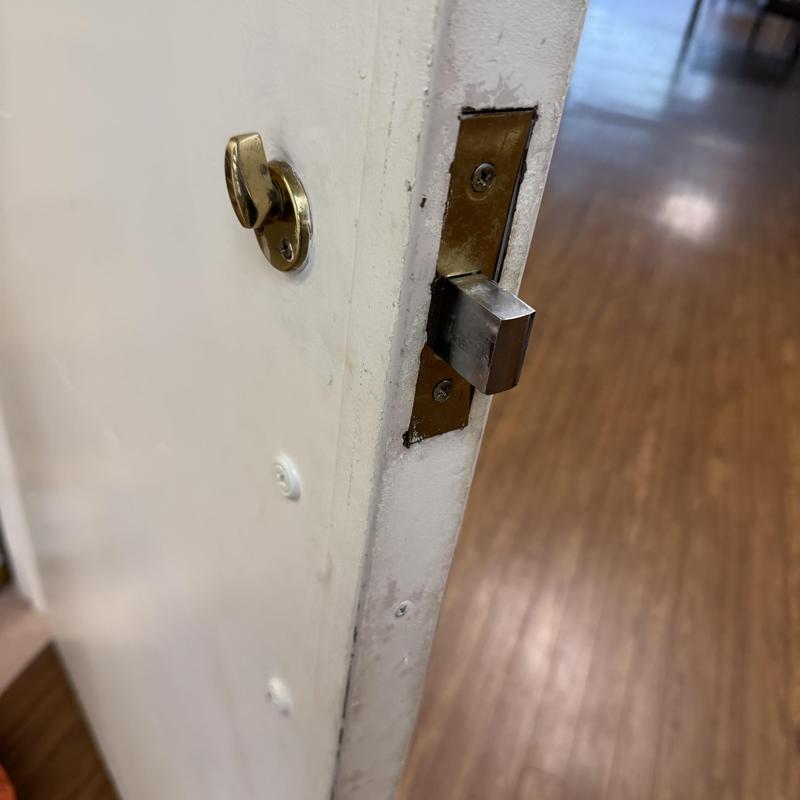 Door latch and deadbolt lock on medical room door
