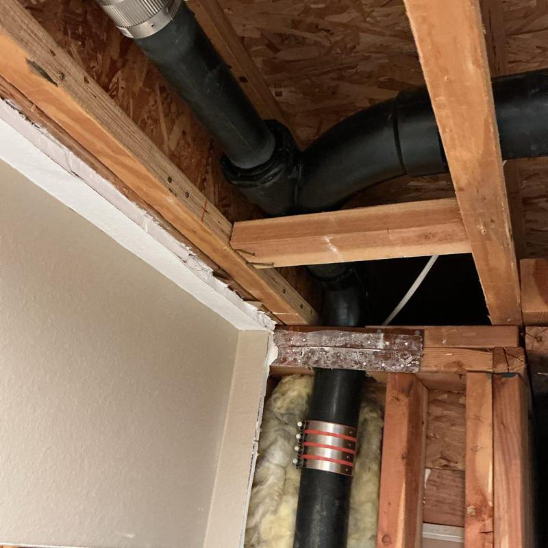 Plumbing stack pipe with drywall cut for access