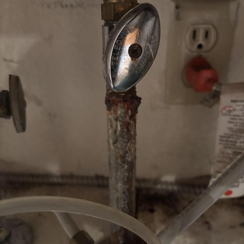 Galvanized water supply pipe with corrosion and valve