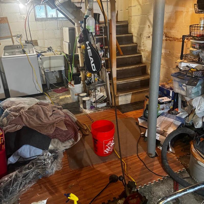 Basement floor drain with plumbing tools and supplies