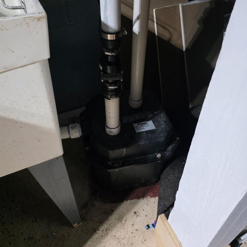 Laundry pump installation with connected PVC piping