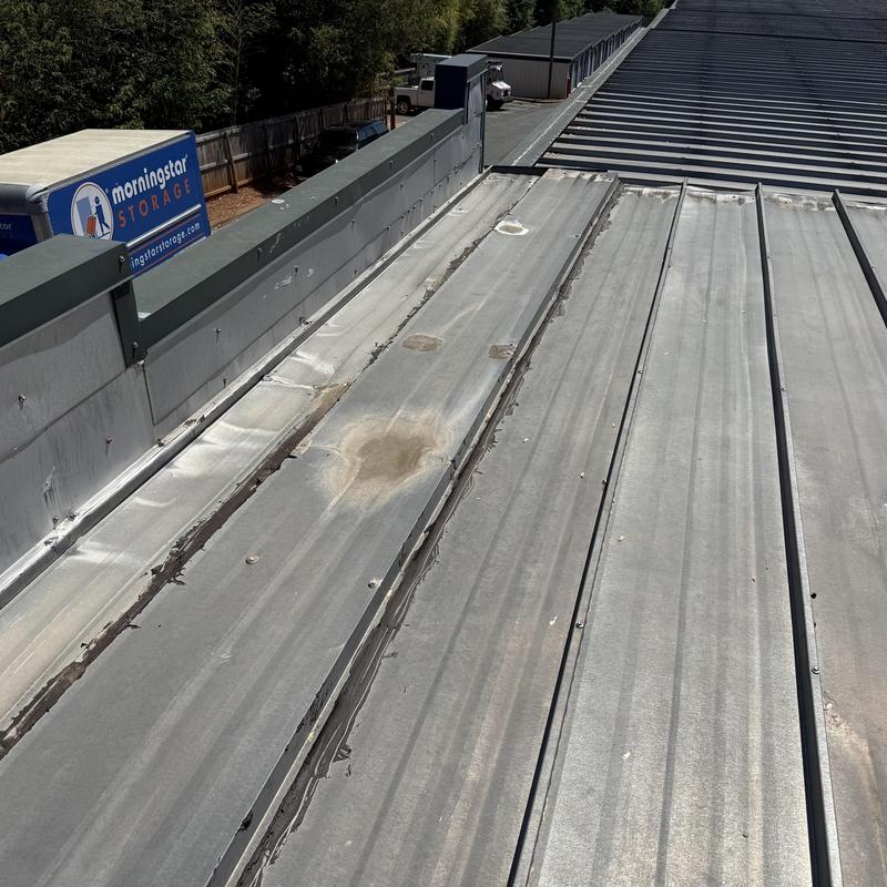 Metal roof panel damage and wear inspection at storage facility