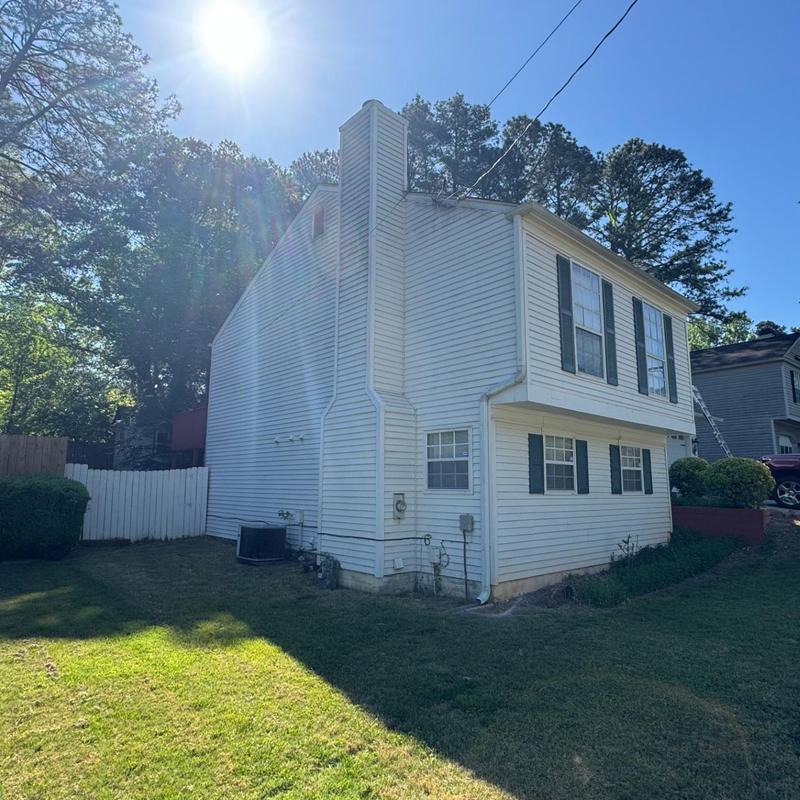 House siding and chimney exterior with sun glare