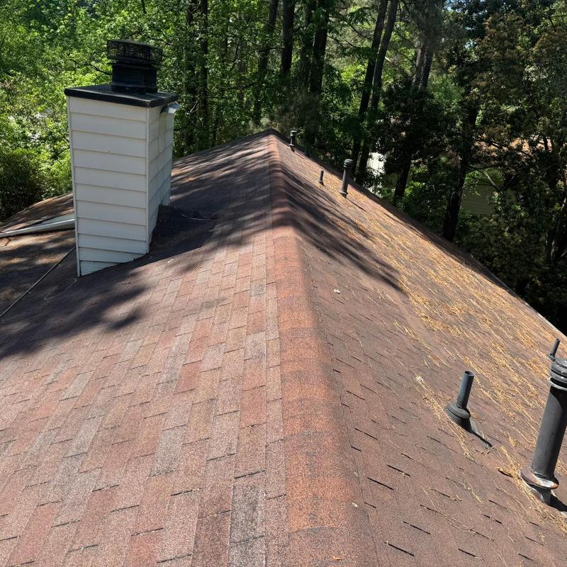 Asphalt shingle roof with chimney and vent pipes
