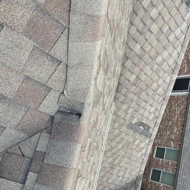 Architectural shingles with damaged ridge patch repair