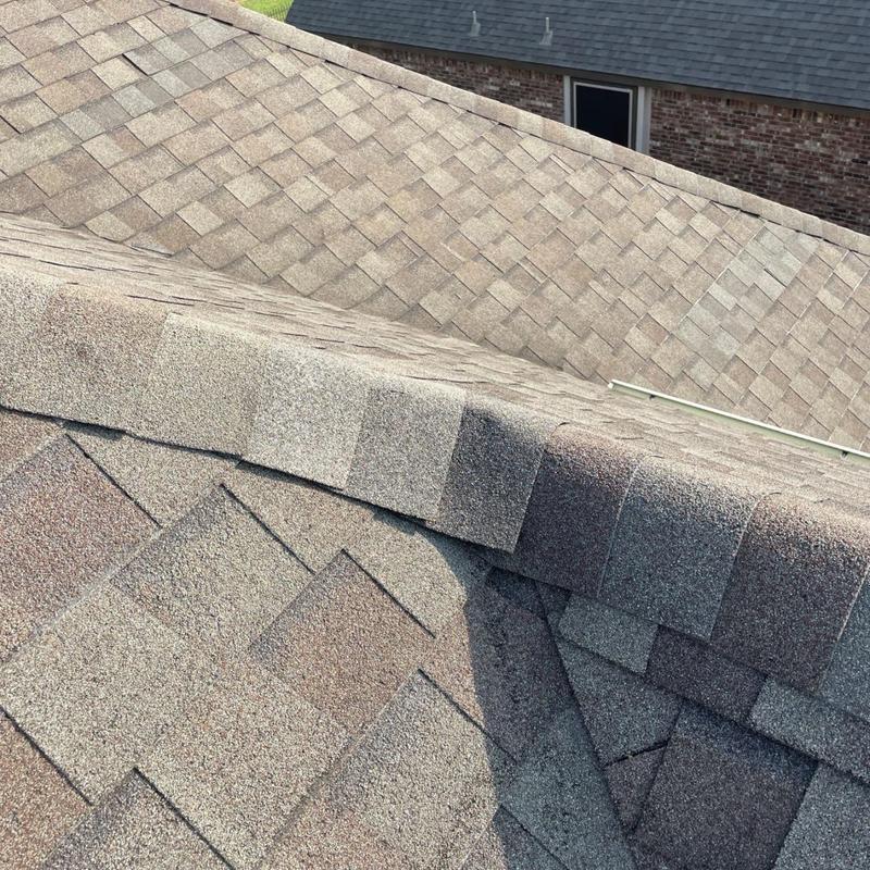 Architectural shingles near roof ridge and slope transition